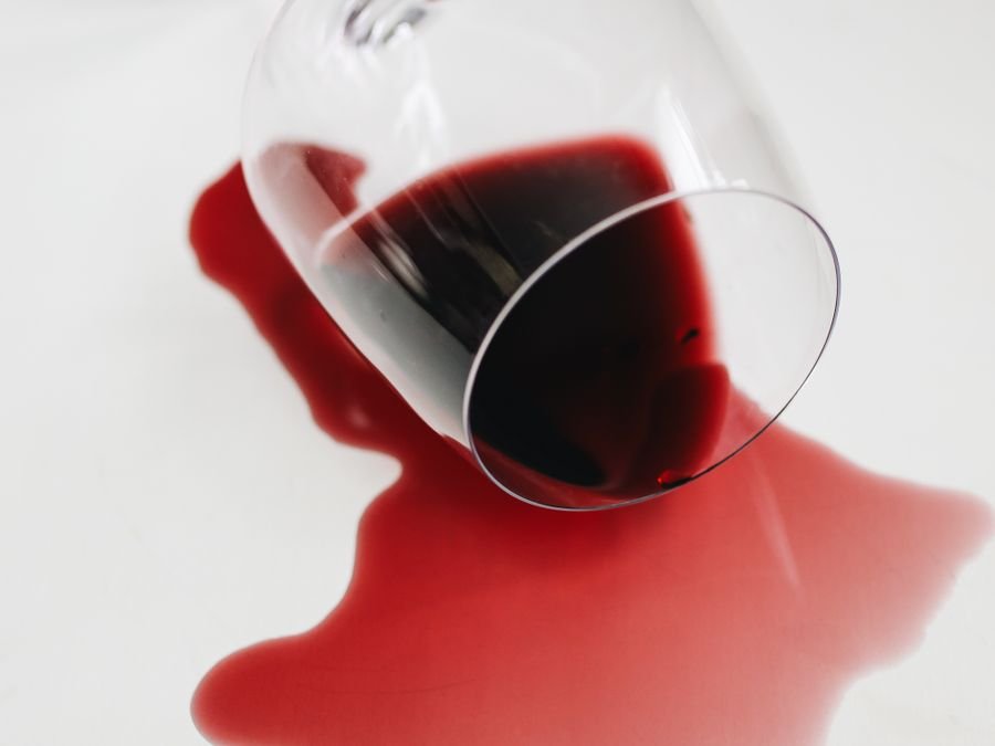Red wine spill on light fabric — a common upholstery stain Cleanitize removes in Singapore