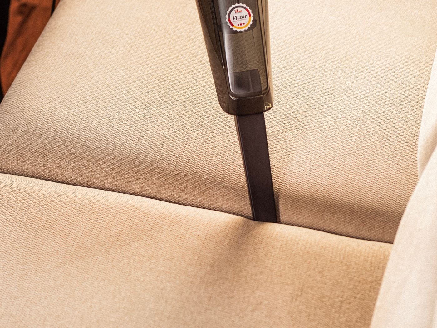 Fabric sofa being vacuum-cleaned in Singapore by Cleanitize