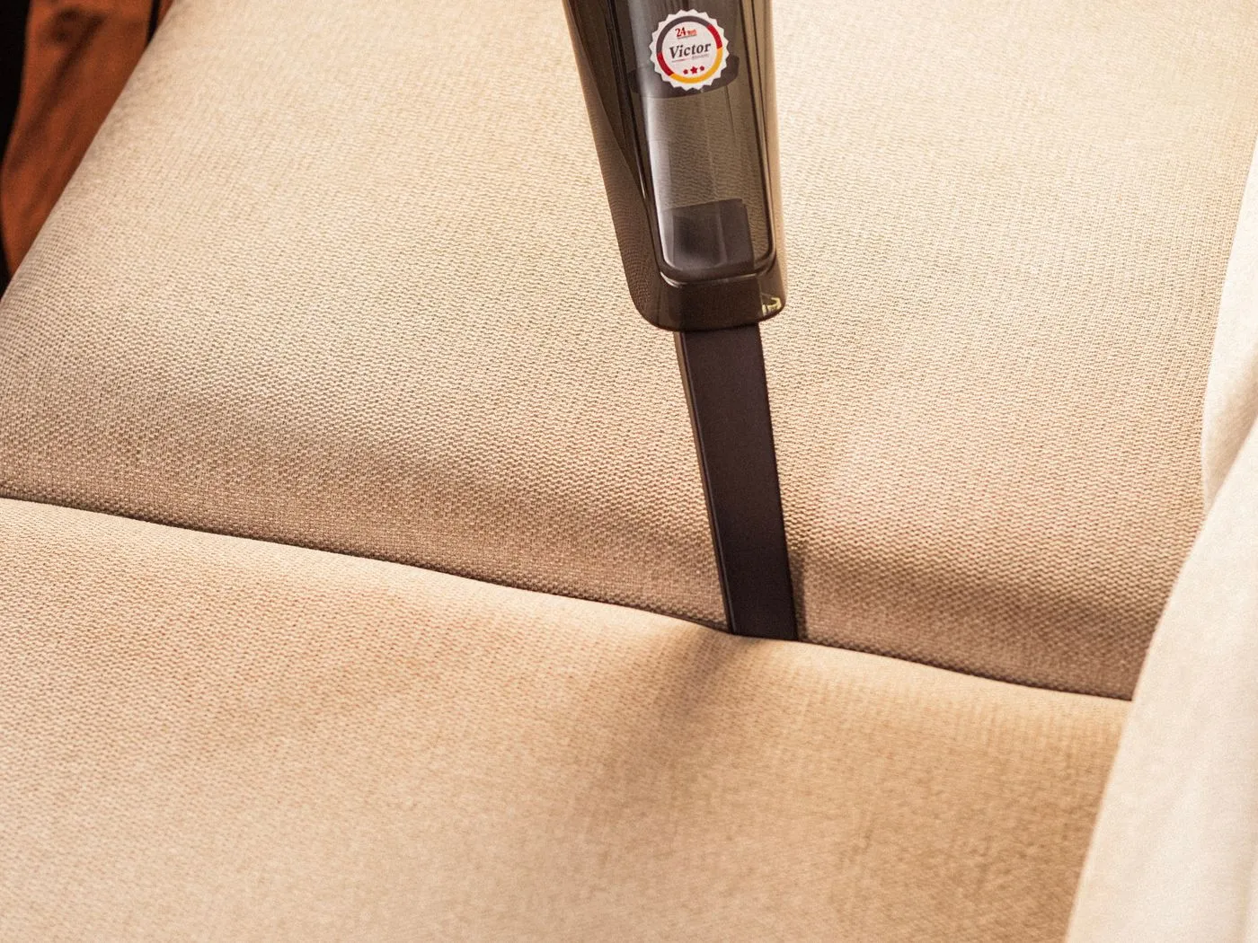 Fabric sofa being vacuum-cleaned in Singapore by Cleanitize
